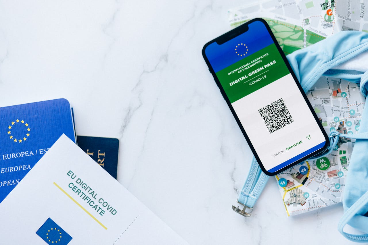 EU digital COVID certificate with smartphone, passports, and map symbolizing travel and vaccination support.